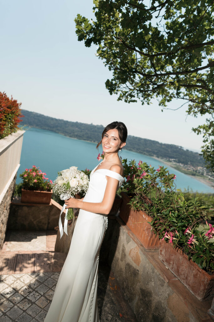 Smiling bride holding white bouquet. | Gabys Films