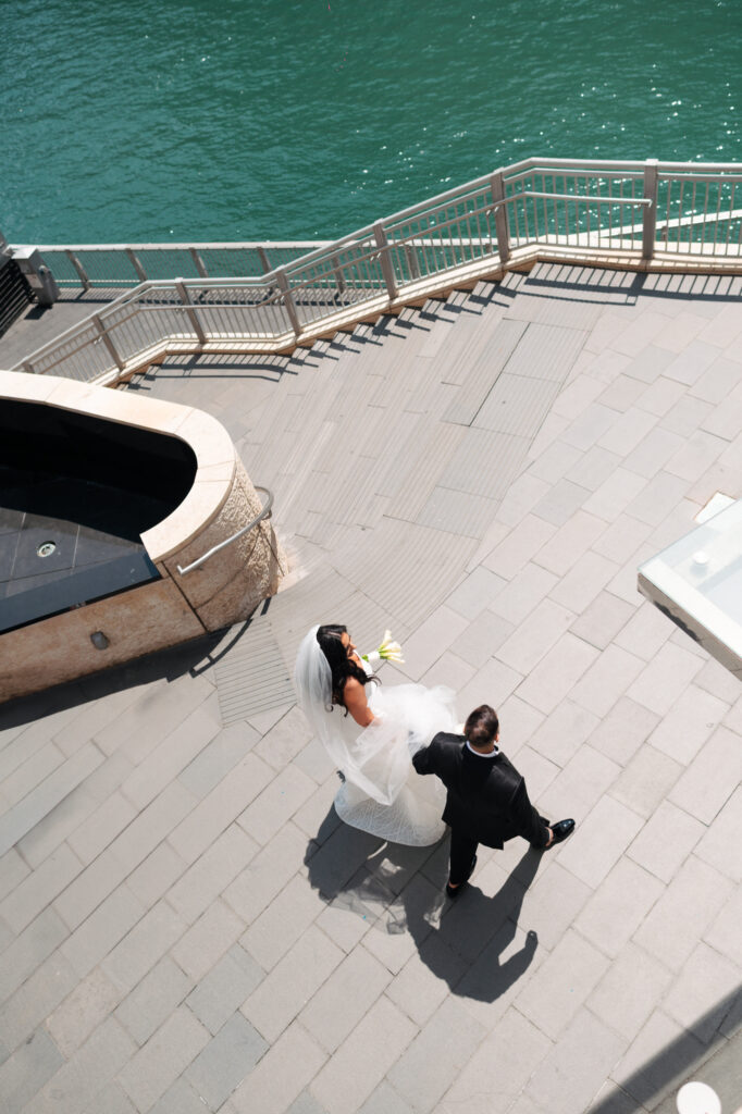 Wedding couple walking near water. | Gabys Films