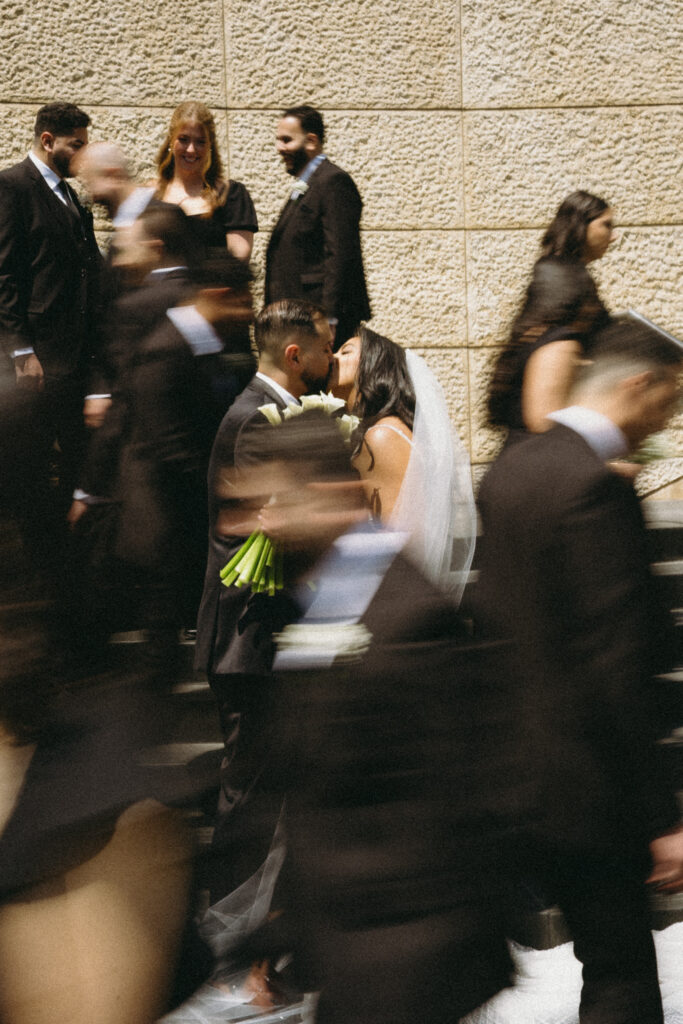 Wedding couple kissing on stairs. | Gabys Films