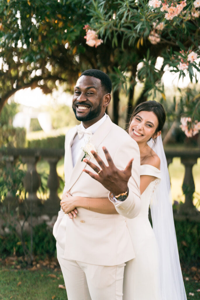 Smiling newlyweds posing outdoors together. | Gabys Films