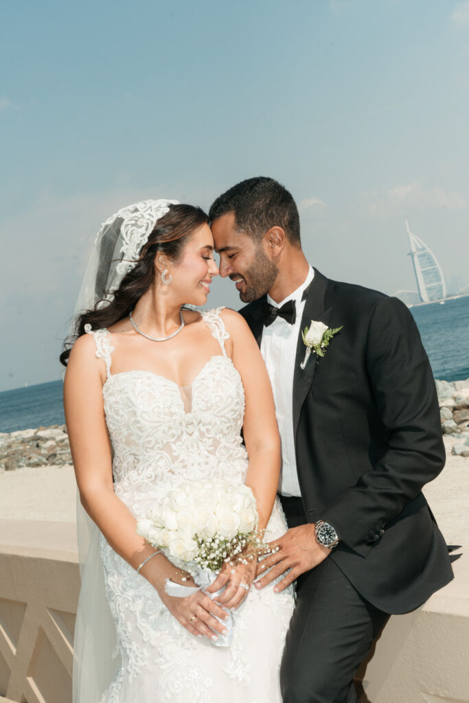Wedding couple posing by beach. | Gabys Films