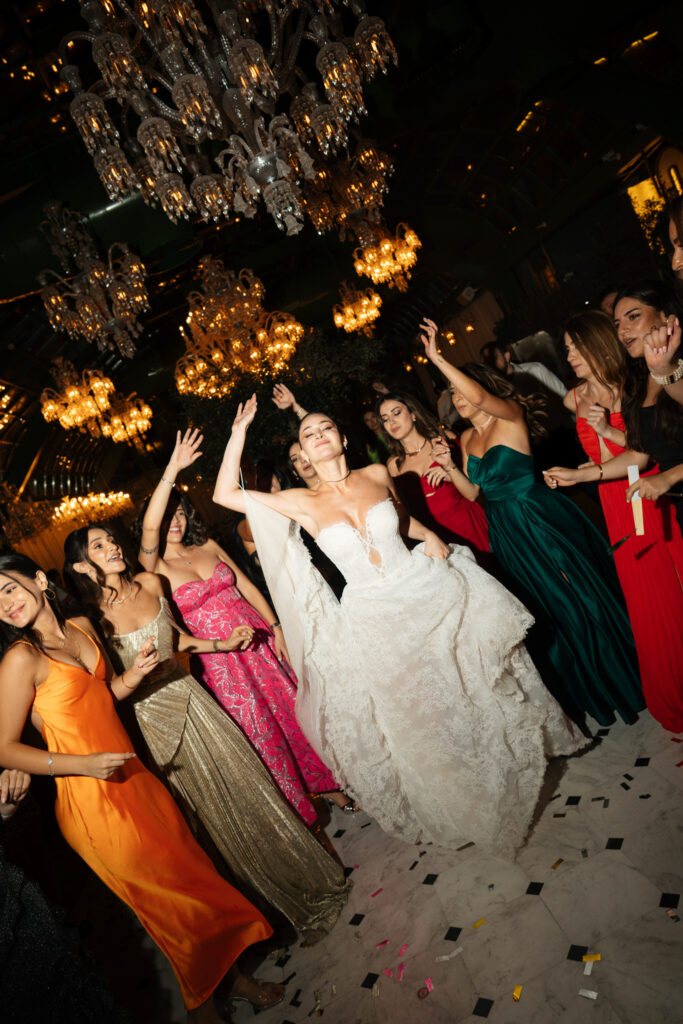 Bride dancing amidst wedding guests. | Gabys Films
