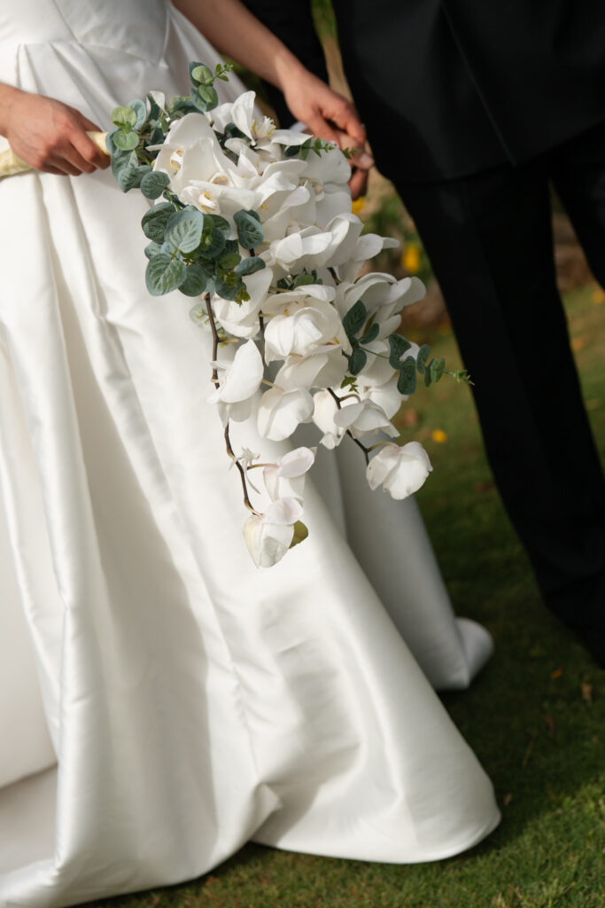 Cascading white orchid bridal bouquet. | Gabys Films