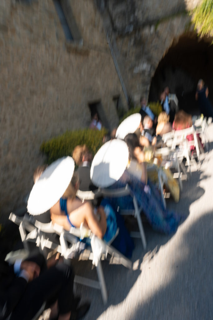 Blurred guests seated at wedding. | Gabys Films