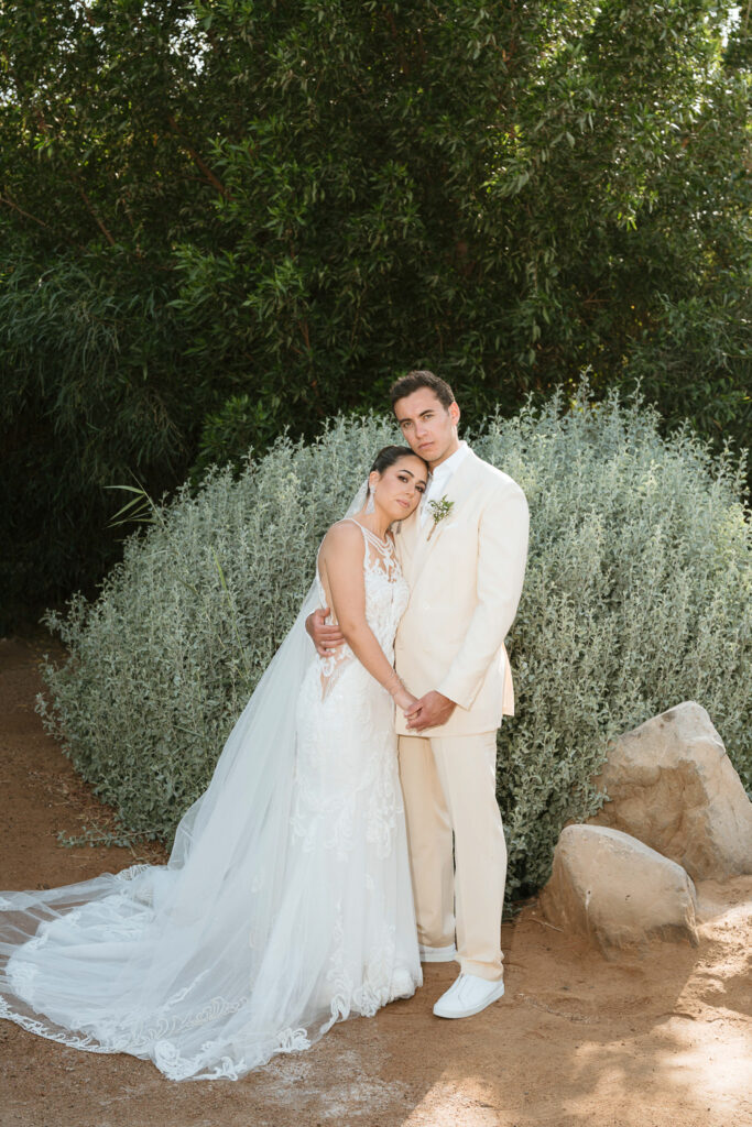 Wedding couple posing near greenery | Gabys Films