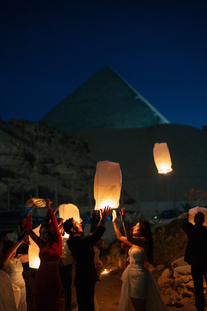 People releasing lanterns near pyramid. Gabys Films