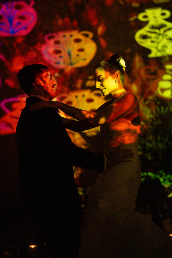 Couples dancing in colorful lighting. | Gabys Films