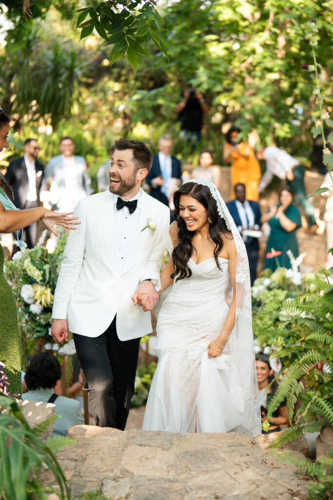 Happy newlyweds walking outdoors together. | Gabys Films