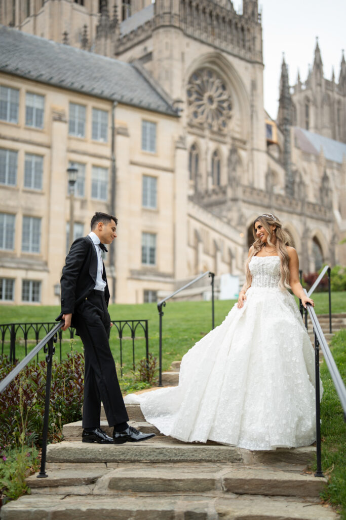 Newlyweds posing outside historic cathedral. | Gabys Films