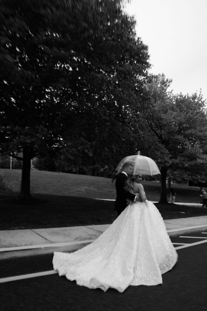 Wedding couple under clear umbrella. | Gabys Films