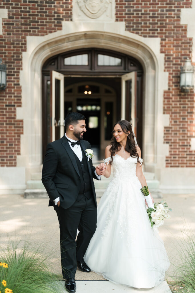 Newlyweds walking outside brick building | Gabys Films