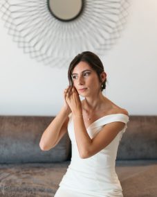 Bride putting on pearl earrings. | Gabys Films
