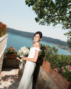 Smiling bride holding white bouquet. | Gabys Films